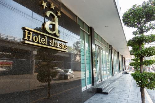 a hotel algas sign on the side of a building at Hotel Expo Abastos in Guadalajara
