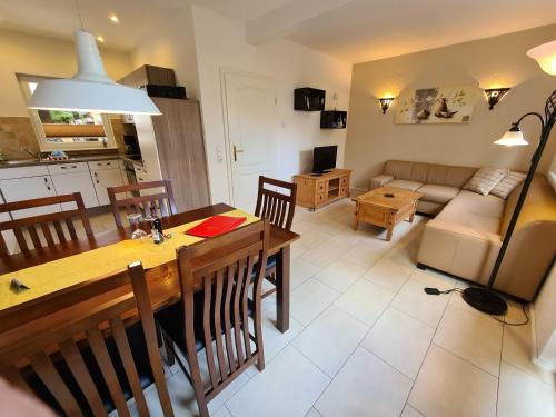 a kitchen and living room with a table and a couch at Ferienhaus Dat Fischerhus in Kellenhusen