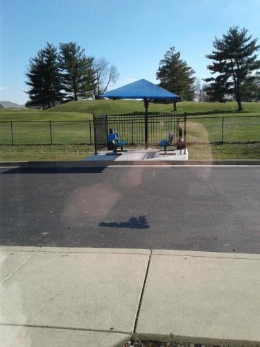 a gazebo with two benches in a park at InTown Suites Extended Stay Indianapolis IN - Greenwood in Greenwood