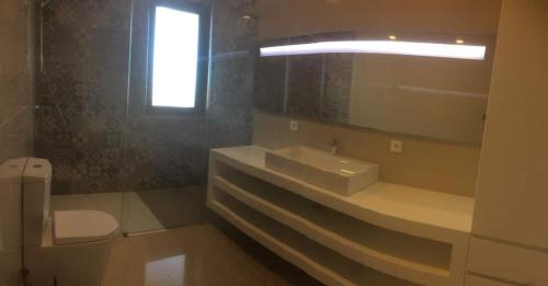 a bathroom with a sink and a toilet and a mirror at Villa Casa Tranquilespiral Alcobaça-Nazare in Mendalvo