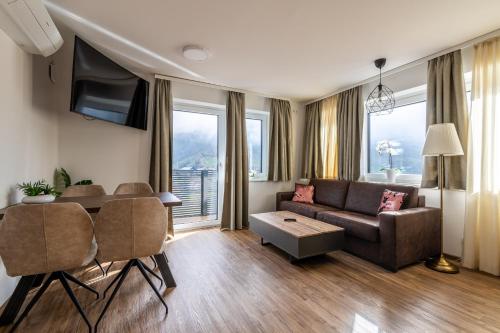 uma sala de estar com um sofá e uma mesa em Amelies Mountain View em Kaprun