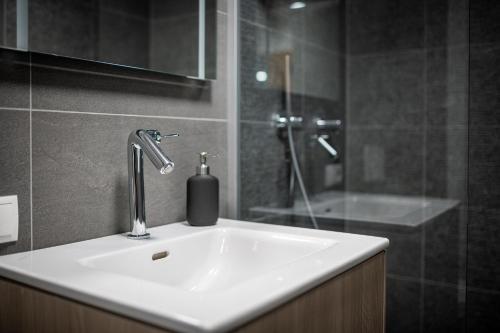 a bathroom with a sink and a shower at Amelies Mountain View in Kaprun