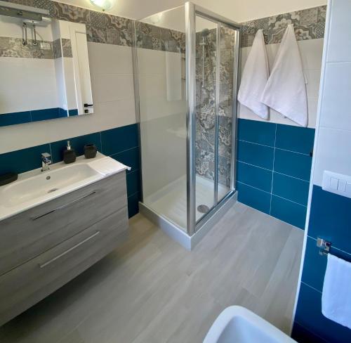 a bathroom with a shower and a sink at Cala Gonone - Casa del Mirto in Cala Gonone
