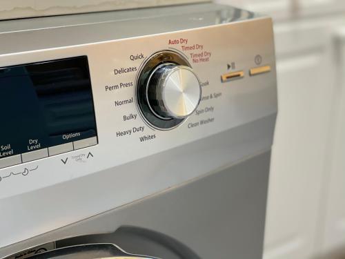 a close up of a washing machine knob at The Loft at Charlotte's Rose in Charlottetown