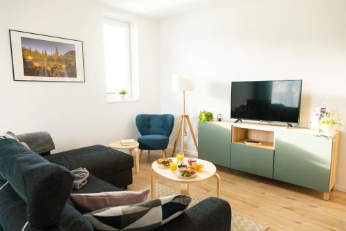a living room with a couch and a tv at Apartmán Vila Zuberec in Zuberec
