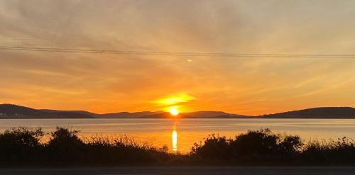 a sunset over a large body of water at Sunrise House in Albany