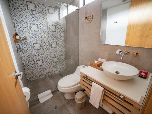 a bathroom with a white toilet and a sink at Luxury Room KAIA - Best Place in Quito in Quito