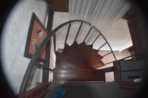 a close up of a wooden spiral stair case at Hosteria Casa Giralda in Baños