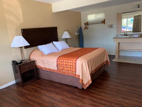 a hotel room with a bed and a sink at Redwood Inn in Santa Rosa