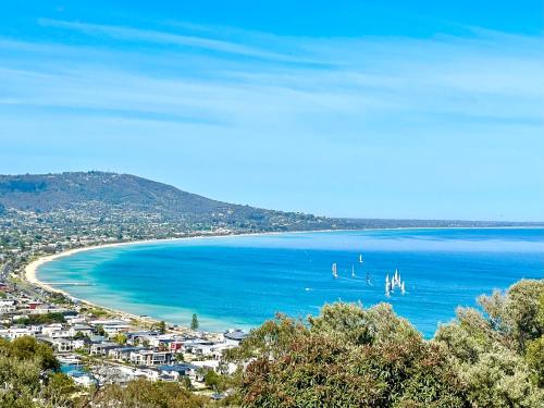 a view of a beach with boats in the water at Kinoie Mornington - OCEANVIEW in Mount Martha