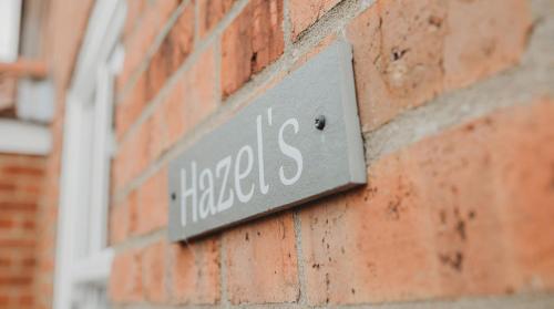 a sign on the side of a brick building at Hazel's in Leiston