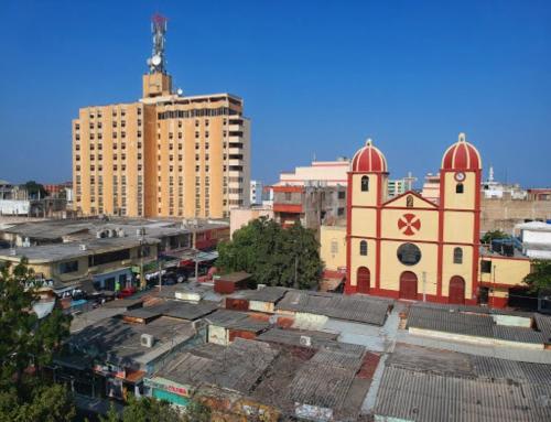 a building with two domes on top of a city at Maicao Internacional in Maicao