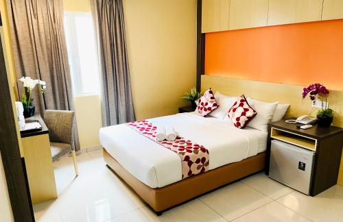a hotel room with a bed and a phone at City Central Hotel in Kuala Lumpur