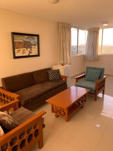 a living room with a couch and a table at Maicao Internacional in Maicao