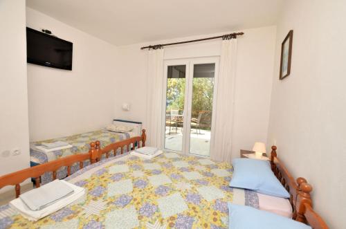 a bedroom with a bed and a window at Apartment Anica in Štivan
