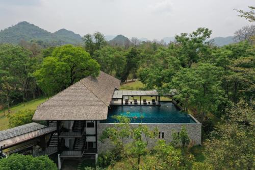 an aerial view of a house with a swimming pool at Rain Tree Residence Hotel in Phayayen