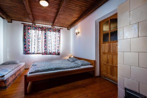 a bedroom with two beds and a window at Chalupa Zubrik Telgárt in Telgárt