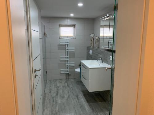 a bathroom with a white sink and a toilet at Ferienwohnung Am Müritz Seeufer in Waren