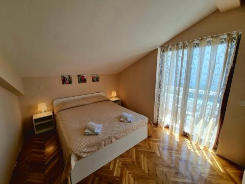 Ένα ή περισσότερα κρεβάτια σε δωμάτιο στο Apartments Ostrea - Ana