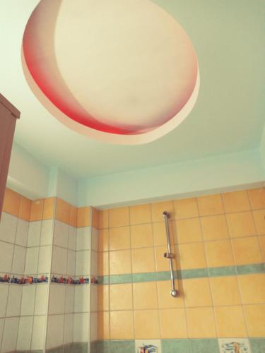 a bathroom with a ceiling with a large light at oniron in Sidhirókastron