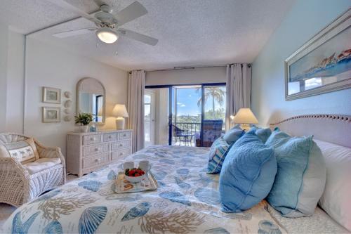 a bedroom with a bed with a tray of fruit on it at Harbor Towers 1 Bedroom Pool View in Siesta Key