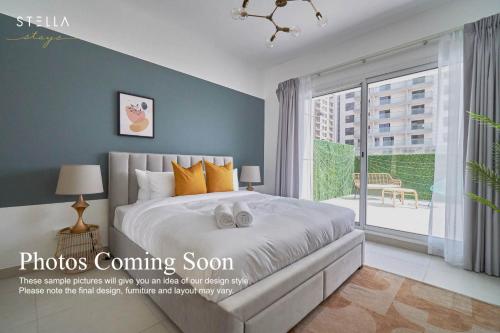 a bedroom with a large bed and a large window at Stella Stays Charming 1 BDR Dubai JVC Private Balcony in Dubai