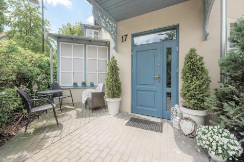 a blue door on a house with a patio at JM Sopot Apartament Haffner in Sopot
