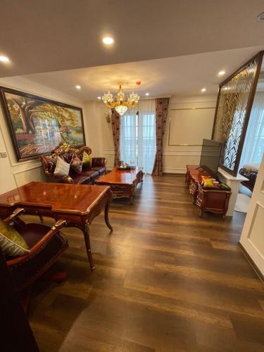 a living room filled with furniture and a chandelier at Camellia Luxury Hotel Tam Đảo in Tam Ðảo