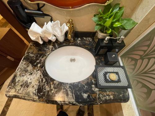 a bathroom sink with a black and white counter top at Camellia Luxury Hotel Tam Đảo in Tam Ðảo