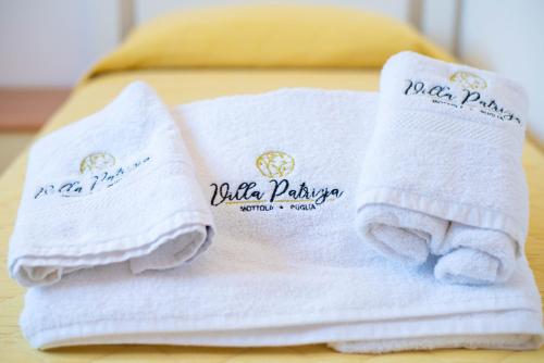 two towels sitting on top of a bed at Villa Patrizia-Luxury Villa in Mottola