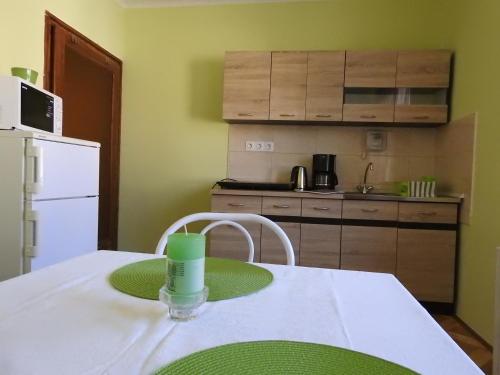 a kitchen with a table with a green plate on it at Haus Gizella in Harkány