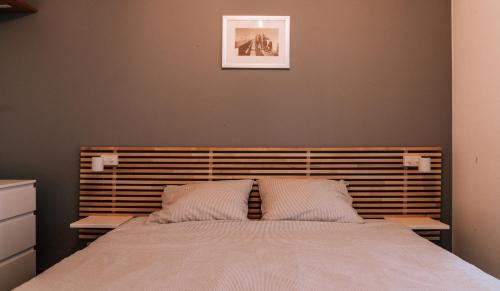 a bedroom with a large bed with two pillows at Casa MaTi in Blankenberge