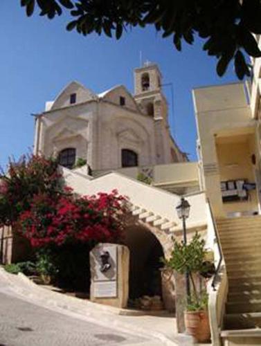 a building with a clock tower on top of it at Katikies 22 in Pissouri