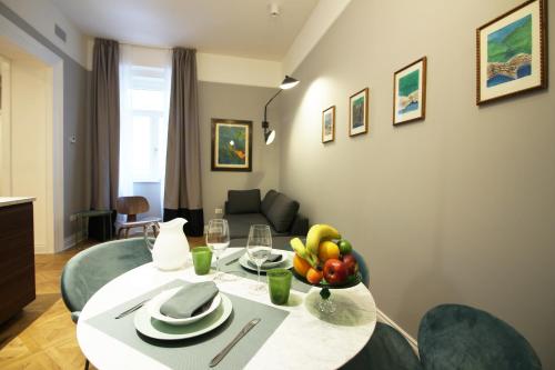 a dining room table with a bowl of fruit on it at Le Porte Blu in Trieste