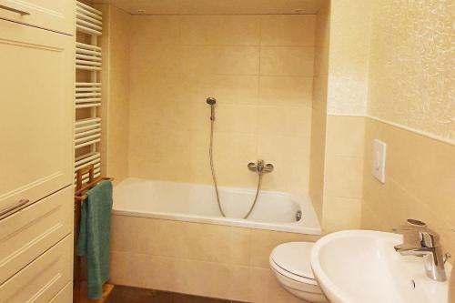 ein Badezimmer mit einer Badewanne, einem WC und einem Waschbecken in der Unterkunft Luxus Ferienwohnung mit hochwertiger Ausstattung Wintergarten in Cottbus