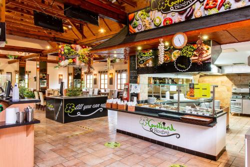 a fast food restaurant with a counter with food at Gastland M0 Hotel & Conference Center in Szigetszentmiklós