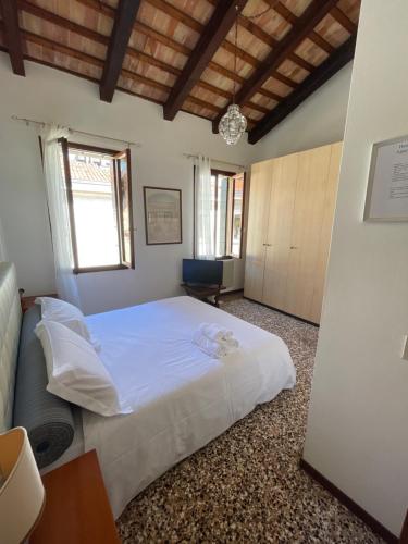 a bedroom with a large white bed in a room at Hesperia Apartment in Treviso