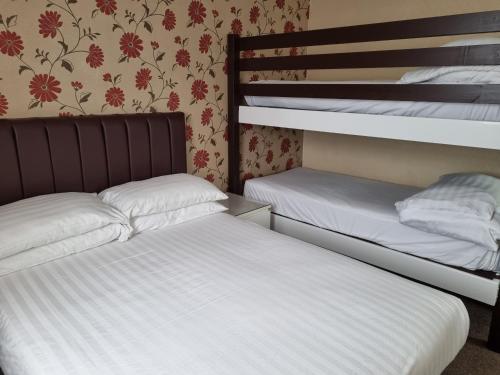 a bedroom with two bunk beds and a wall at The Beechfield Hotel in Blackpool