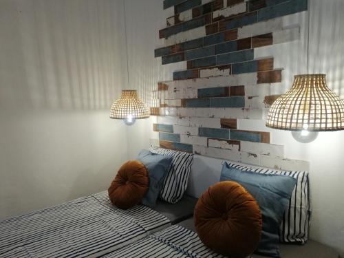 a bedroom with a bed with two lamps and two pillows at The Portuguese Element in Faro