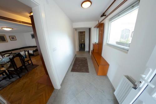 a hallway leading to a dining room with a window at Apartment Vila Tara in Bihać