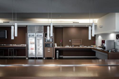 a large kitchen with a refrigerator in the middle at HC3 Hotel in Bologna