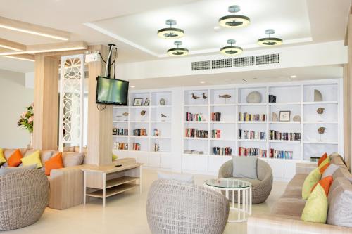 a living room with couches and chairs and a tv at The Sands Khao Lak by Katathani - SHA Extra Plus in Khao Lak
