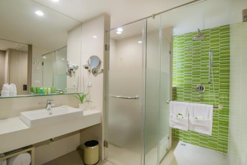 a bathroom with a sink and a glass shower at The Sands Khao Lak by Katathani - SHA Extra Plus in Khao Lak