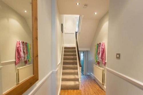 a hallway with a stairway leading to a house at Seaside Retreat in North Bay - with parking in Scarborough