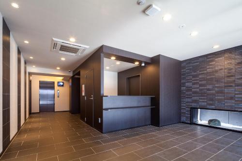 a hallway with a fireplace in a building at HOTEL SUITE HIROSHIMA HAKUSHIMA in Hiroshima