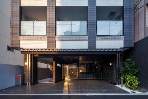 an external view of a building with an entrance at HOTEL SUITE HIROSHIMA HAKUSHIMA in Hiroshima