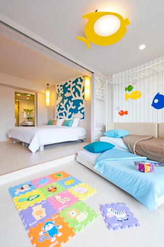 a bedroom with two beds and a rug at The Sands Khao Lak by Katathani - SHA Extra Plus in Khao Lak
