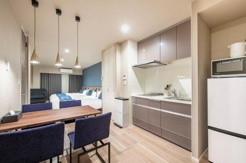 a kitchen and dining room with a bed and a table at hotel aima in Tokyo