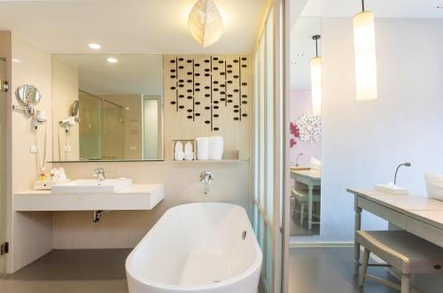 a bathroom with a white tub and a sink at The Sands Khao Lak by Katathani - SHA Extra Plus in Khao Lak