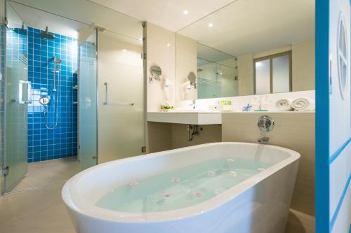 a large bathroom with a tub and a shower at The Sands Khao Lak by Katathani - SHA Extra Plus in Khao Lak